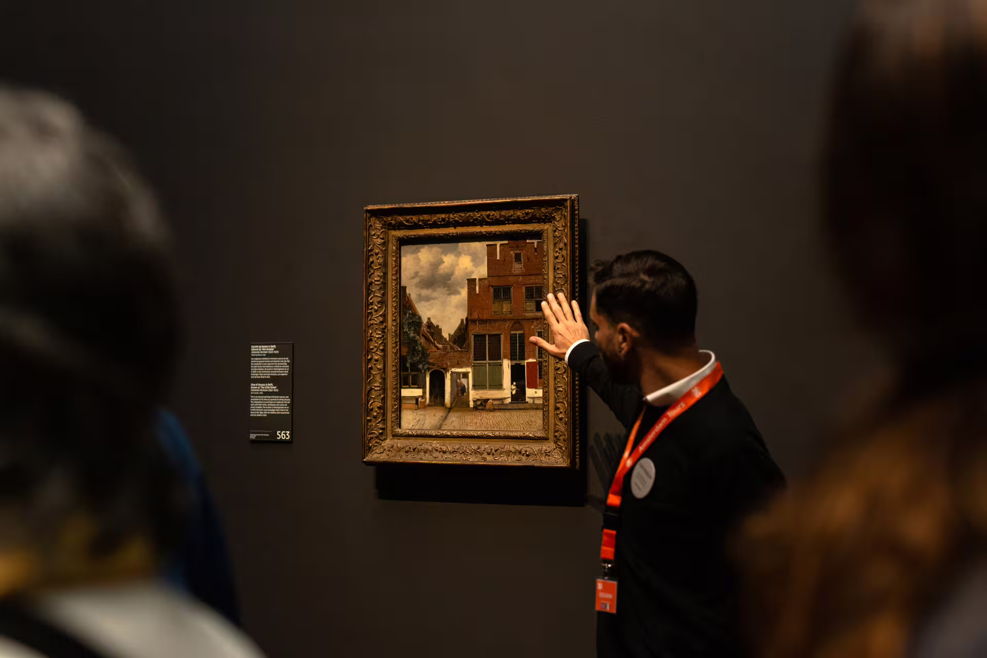 Tour guide explaining Dutch painting at Rijksmuseum during private guided tour, offering an insightful cultural experience.