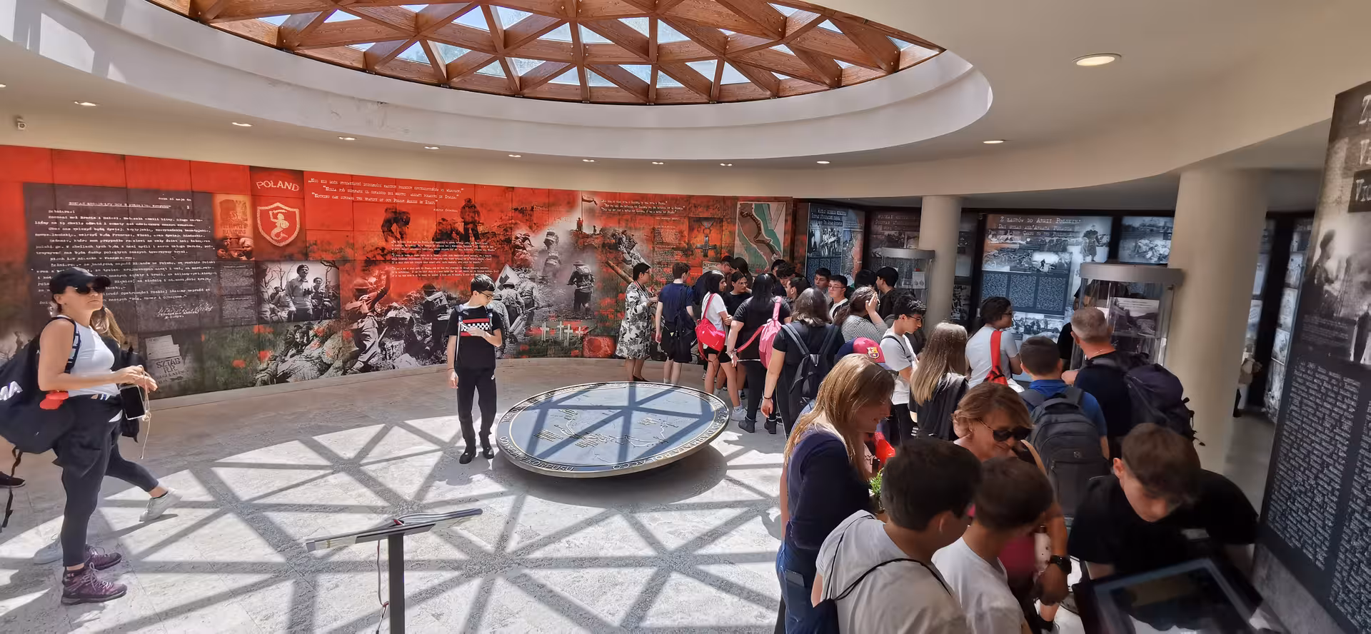 Visitors explore a historical exhibit at L'Anello della Collina Imprendibile, featuring vibrant wartime displays.