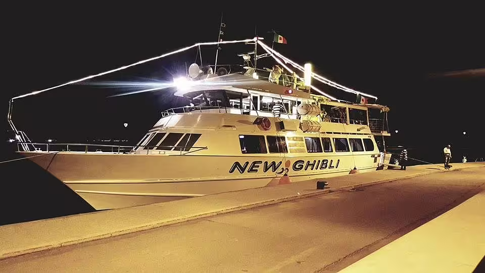 Boat docked at night on the Riviera Romagnola, ready for a half-day coastal cruise from the harbor
