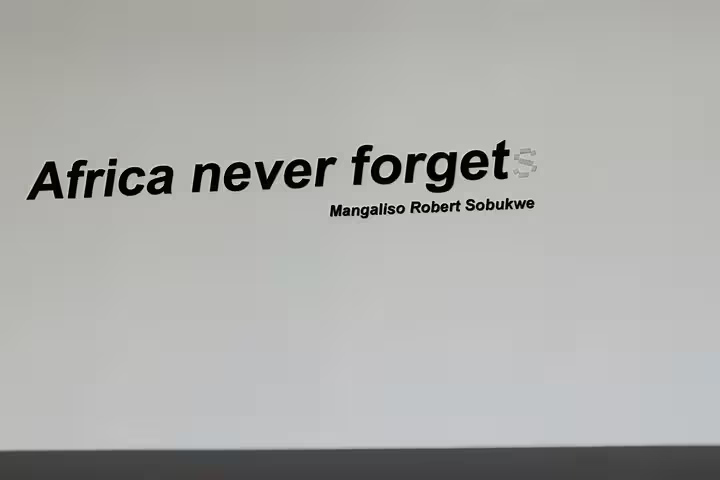 Wall inscription 'Africa never forgets' by Mangaliso Robert Sobukwe at Robben Island Museum, South Africa.