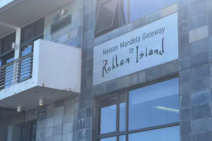 Entrance to Nelson Mandela Gateway for Robben Island tours showcasing modern architecture and signage.