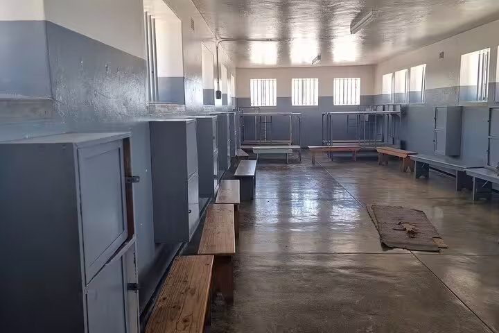Interior view of a historic prison cell block on Robben Island, showcasing the guided museum tour experience.