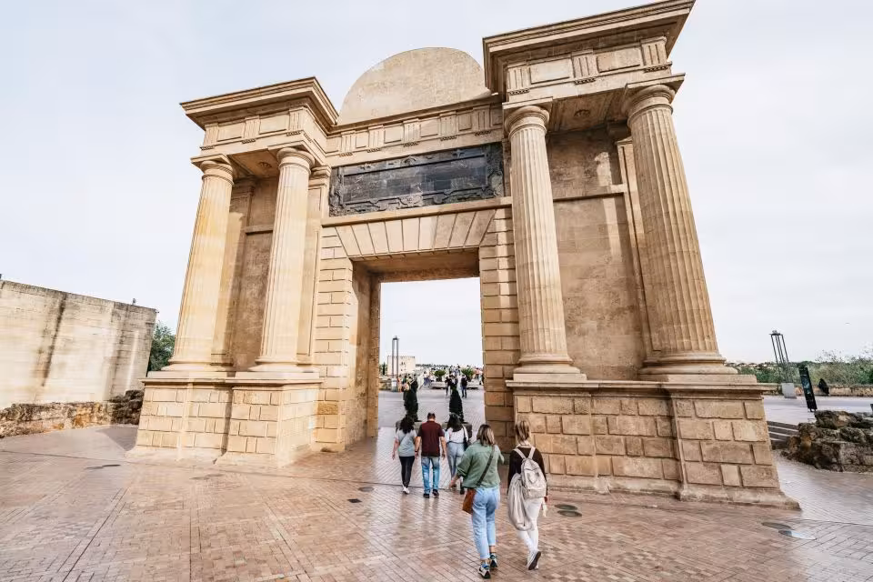 Roman Bridge Gate in Córdoba with visitors entering, key stop on the Free Tour Secretos de la Axerquía walk