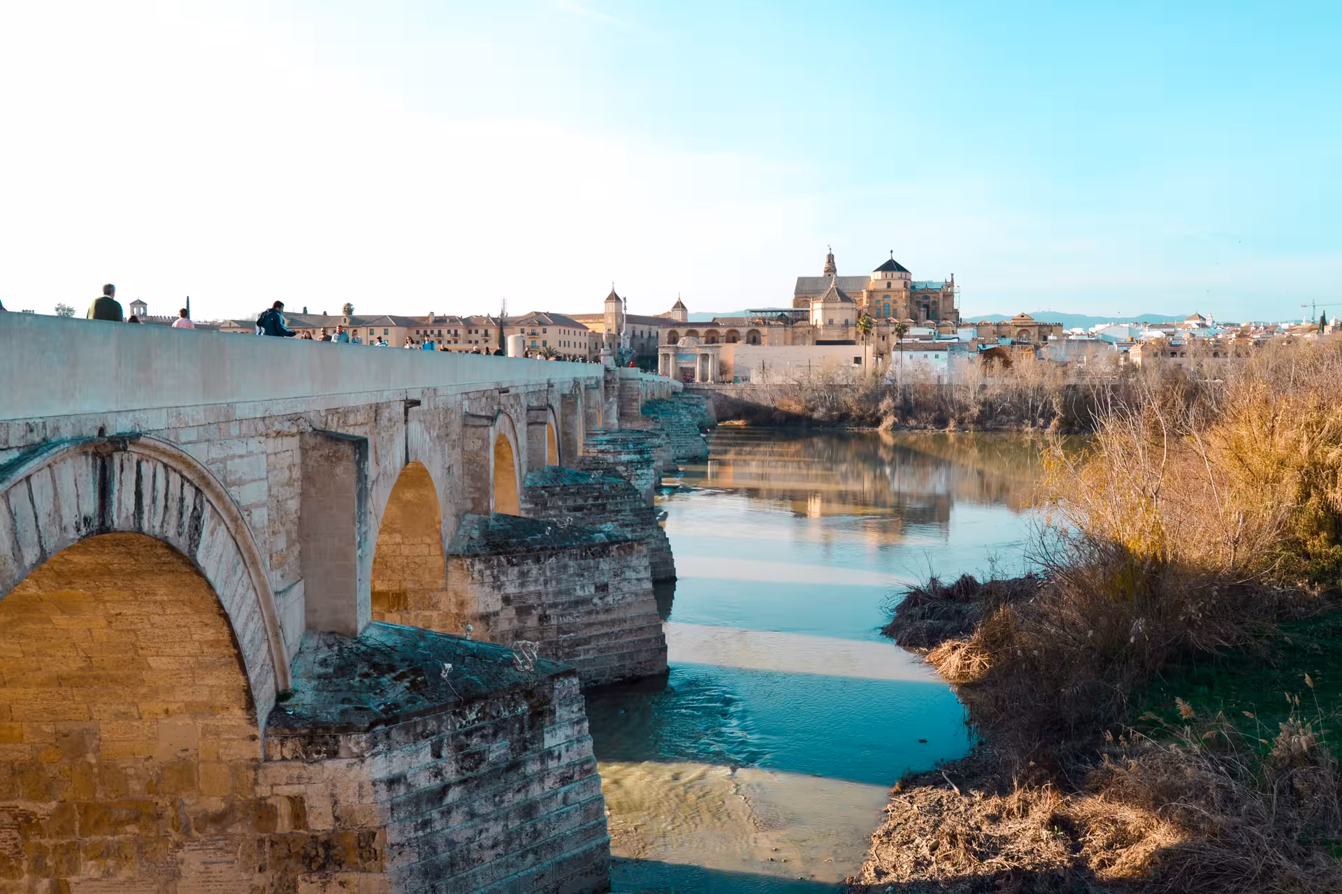 Roman Bridge over the Guadalquivir with Mezquita-Catedral views, highlight of a free tour in Córdoba
