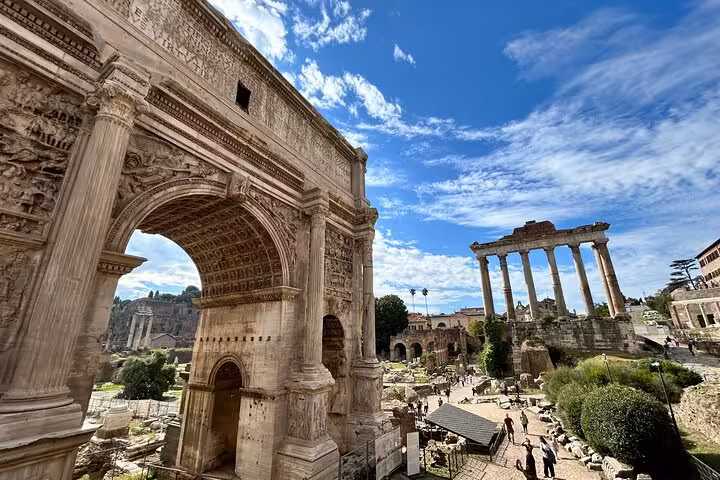 Explore ancient architecture at the Roman Forum, a highlight of the Rome tour with pizza and gelato class.