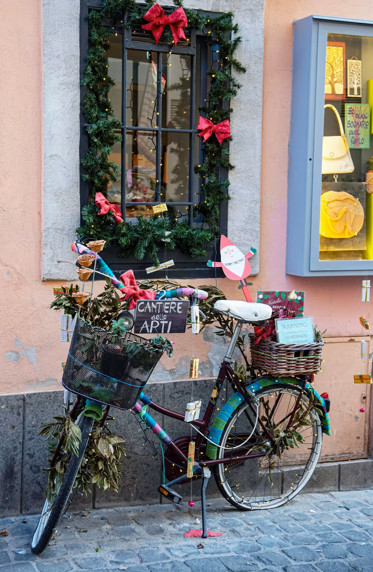 Decorated bicycle with festive garlands in a quaint Italian street, highlighting the Roman Hills Vintage Tour charm.