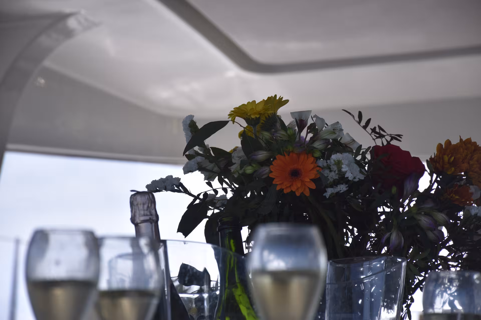 Romantic yacht table with flowers and champagne glasses, ideal setup for a surprise marriage proposal at sea