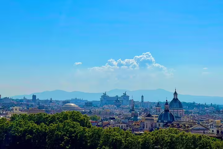 Panoramic skyline of Rome with domes, monuments and distant hills under blue skies on a 3-day private guided city tour