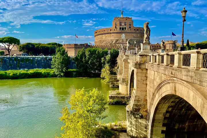 Castel Sant’Angelo and Ponte Sant’Angelo over the Tiber River on a sunny day, featured in a 3-day private Rome tour