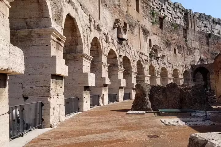 Ancient stone arches and preserved passageways inside the Rome Colosseum, seen on an exclusive arena and Roman Forum tour