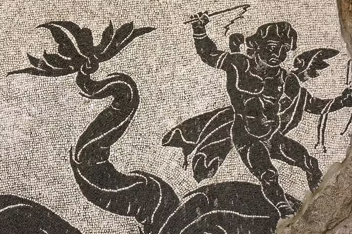 Detailed ancient Roman black and white mosaic depicting a mythological scene at the Baths of Caracalla in Rome