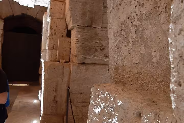 Experience the grandeur of Rome's Colosseum by night, with detailed stone architecture on a guided evening tour.