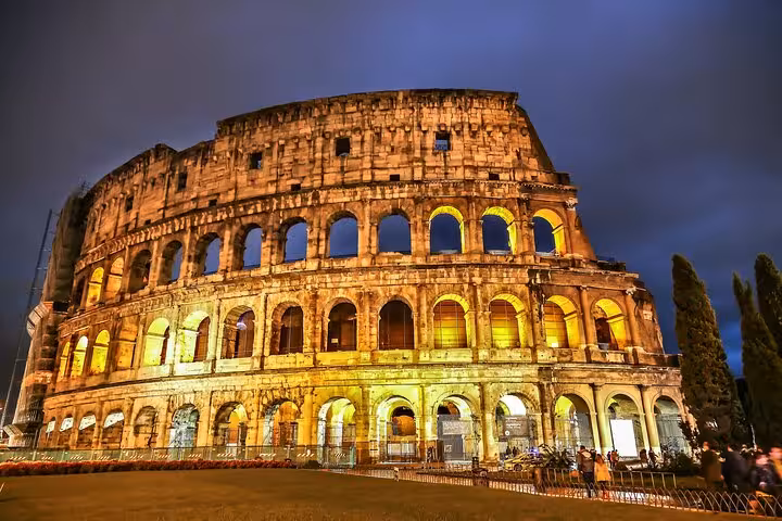 Illuminated Colosseum at night in Rome, ideal for a self-guided Colosseum, Palatine Hill and Forum tour