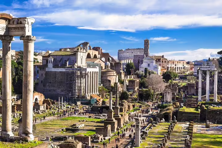 Panoramic view of the Roman Forum ruins with the Colosseum in the background on an exclusive private guided tour in Rome, Italy