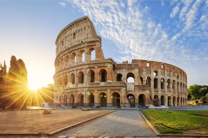 Sunrise over the exterior of the Rome Colosseum, meeting point for exclusive arena and Roman Forum private guided tour
