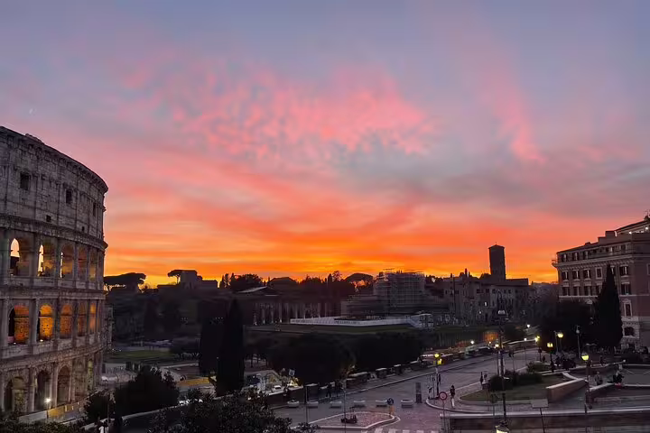 Sunset view of the Colosseum and Roman Forum from a chauffeured Rome by night private sightseeing tour
