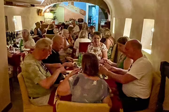Guests enjoy a Fabullus tasting menu with wine pairing in a cozy underground Rome restaurant near Piazza Navona