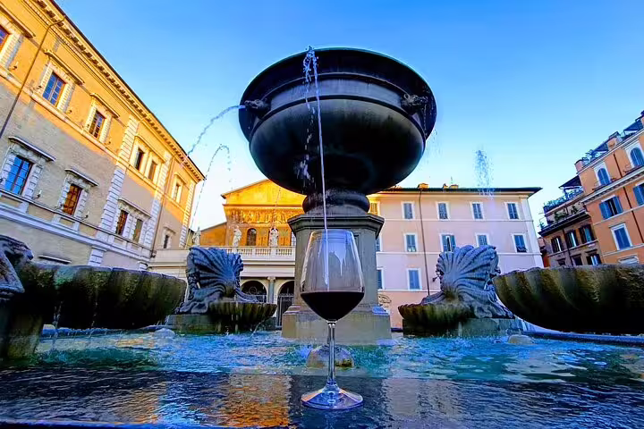 Glass of red wine on a historic Rome fountain in a sunlit piazza, highlighting the Fabullus wine pairing experience.