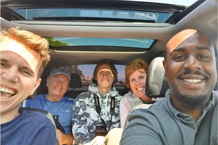 Small group in car on Rome to Florence sightseeing tour, enjoying comfortable transfer for a day trip