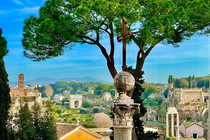 Panoramic view of Roman Forum ruins and green hills from a scenic terrace on an exclusive chauffeured tour of Rome