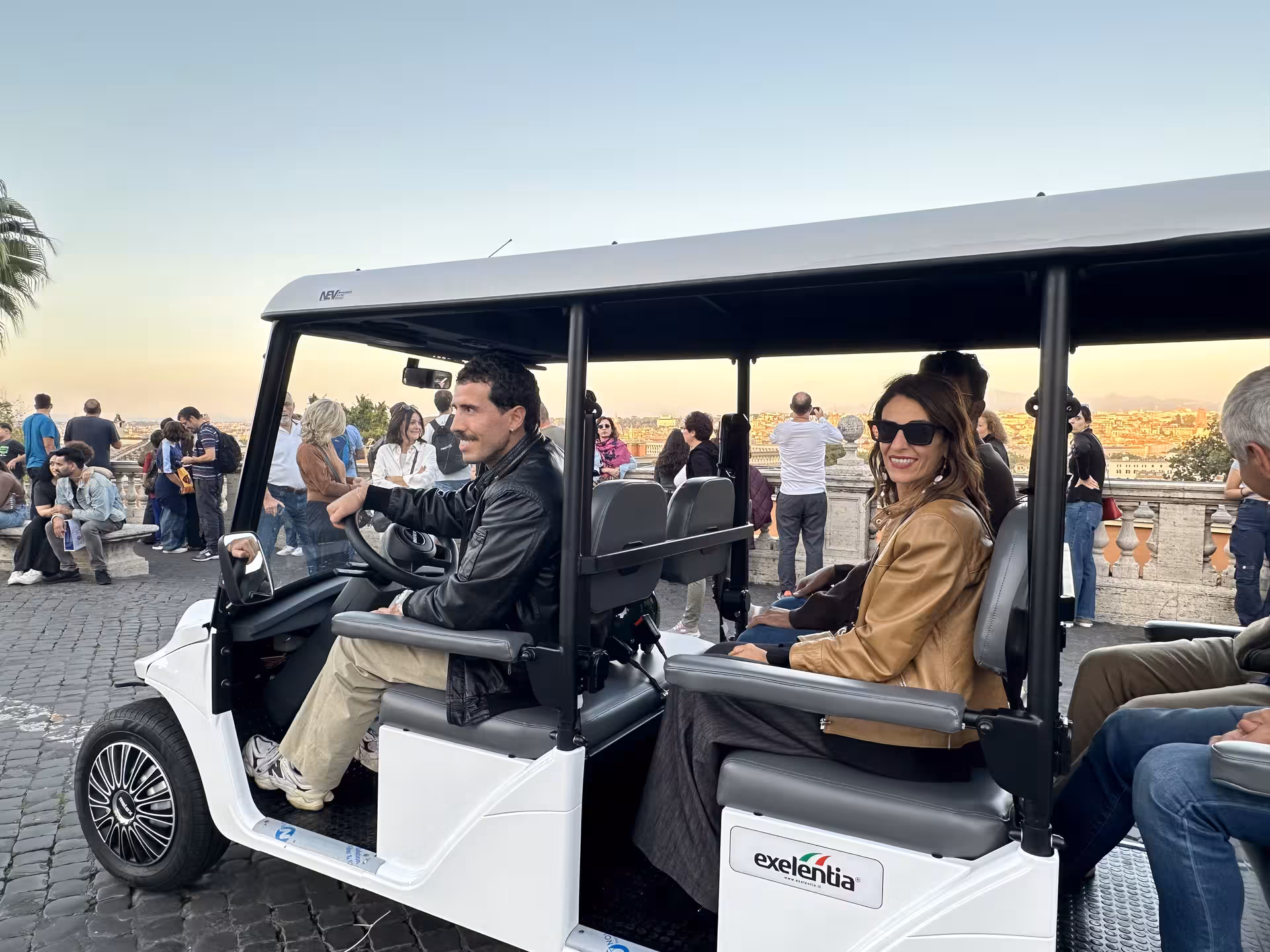 Enjoy a scenic golf cart tour in Rome at sunset, capturing the vibrant cityscape and historic landmarks.