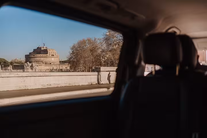 Scenic view of Castel Sant'Angelo from a vehicle window on the Rome Highlights Tour with cooking class.