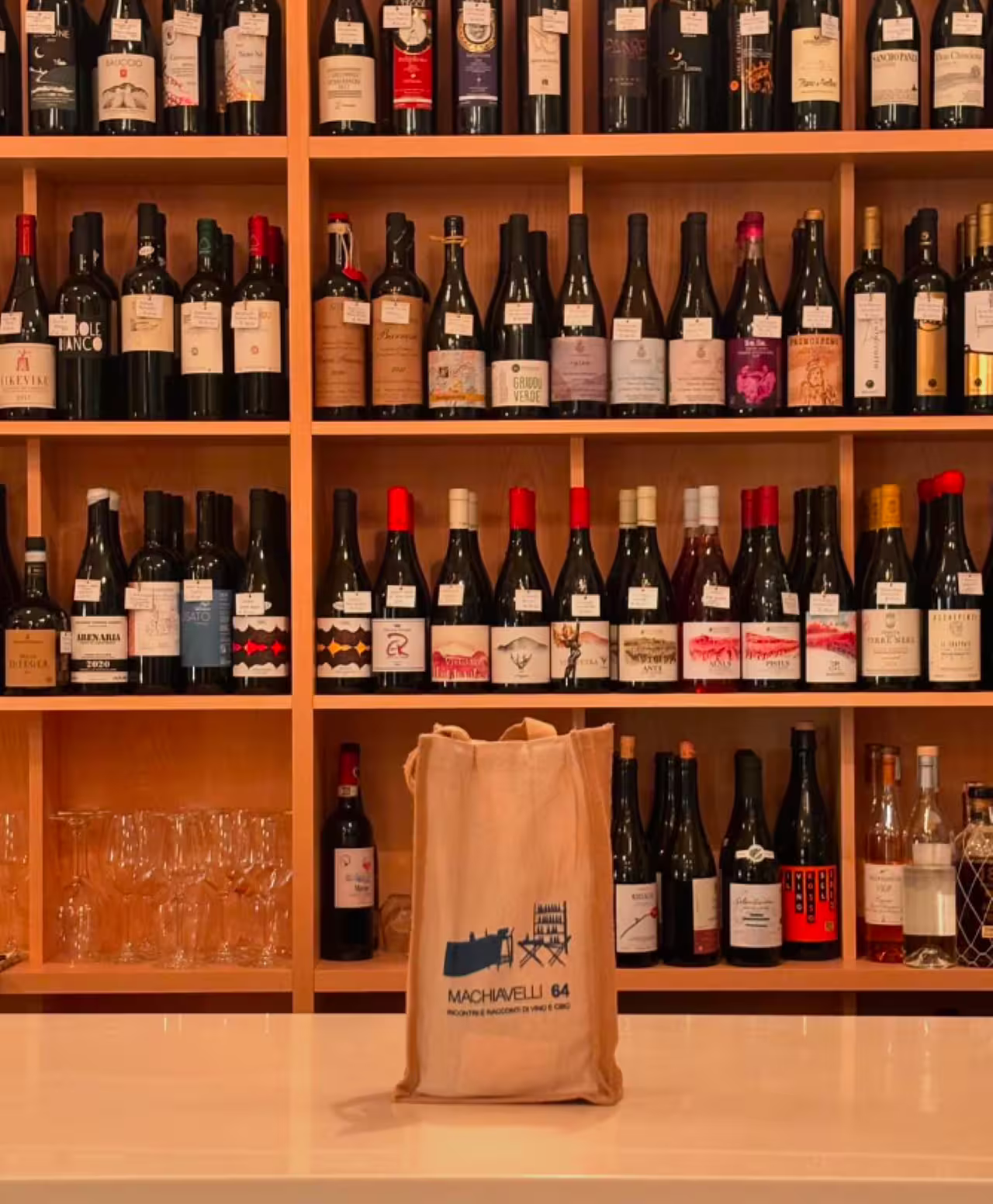 Wine shop shelves in Rome set for authentic Italian wine tasting tour with local labels and glassware