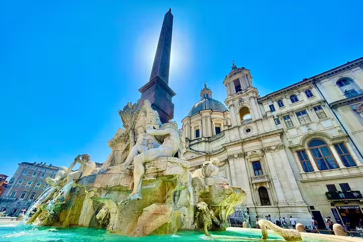 Sunlit Fountain of the Four Rivers and obelisk in Piazza Navona, a highlight of private guided Rome city tours