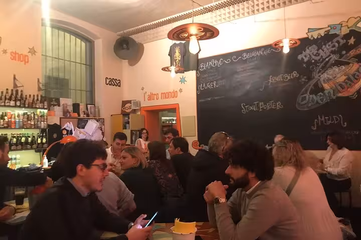 Vibrant Pigneto craft beer bar bustling with patrons enjoying a lively evening in Rome's trendy district.