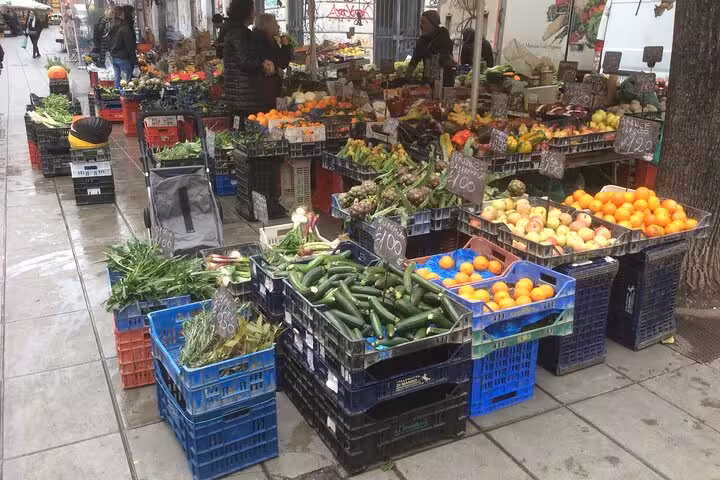 Vibrant outdoor market in Rome's Pigneto district showcasing fresh produce and local flavors.