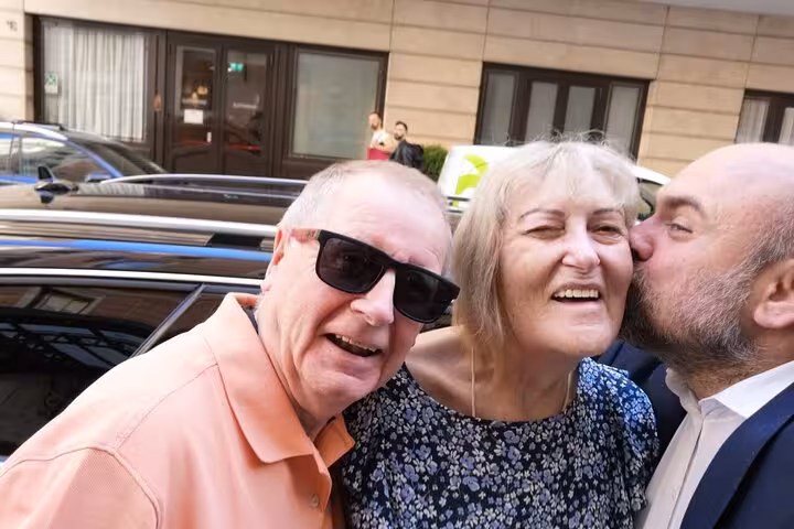 Happy travelers sharing a candid moment during a Rome to Pisa day trip, enjoying a guided Italy tour stop