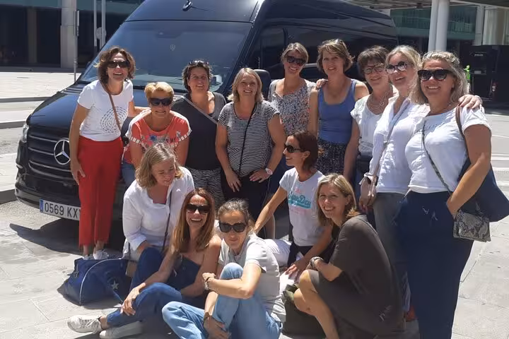 Small group travelers pose by a minivan in Rome before a day trip to Pisa and the Leaning Tower tour
