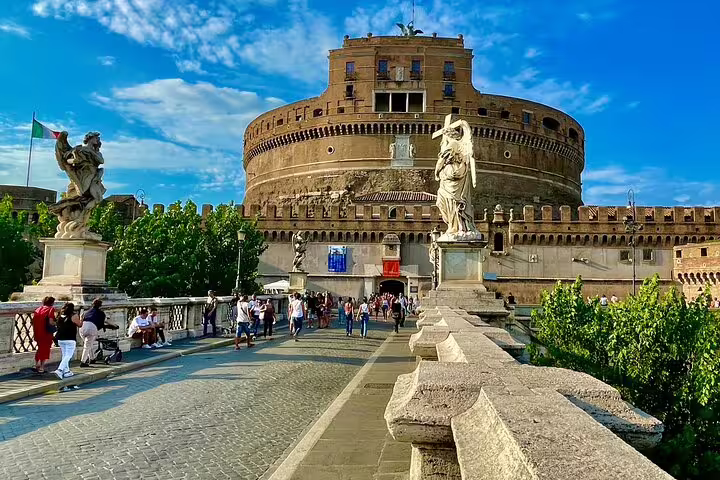 Visitors crossing Ponte Sant’Angelo toward Castel Sant’Angelo in Rome on a private chauffeured sightseeing tour