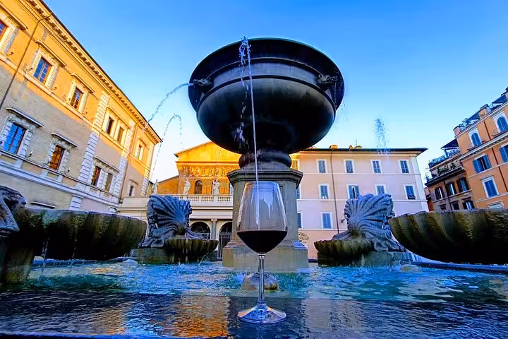 Glass of red wine on a historic fountain in a sunny Roman piazza during a private chauffeured food and wine tour
