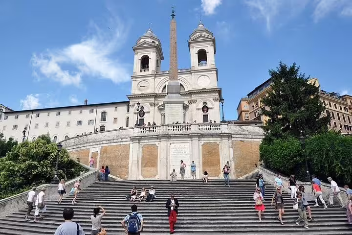 Tourists relaxing on the Spanish Steps below Trinità dei Monti church in Rome during a two days private chauffeured skip the line tour