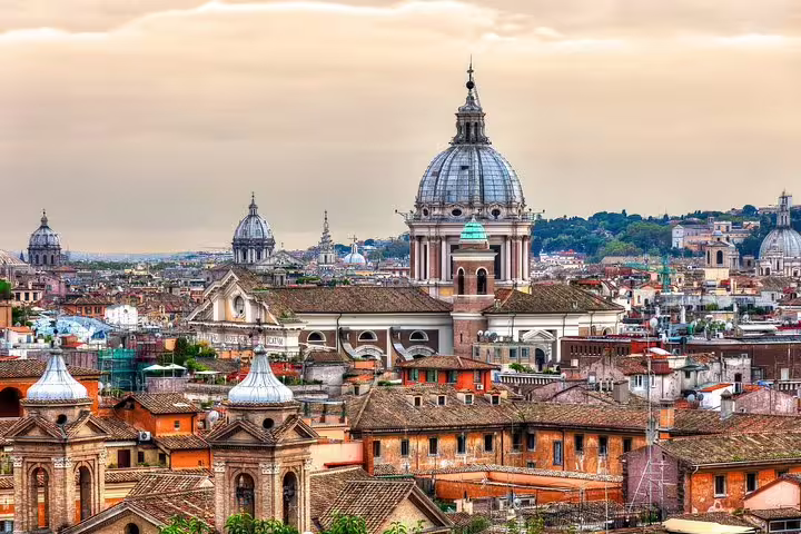 Rome skyline at sunrise with historic domes and terracotta rooftops seen on an early morning guided city highlights tour