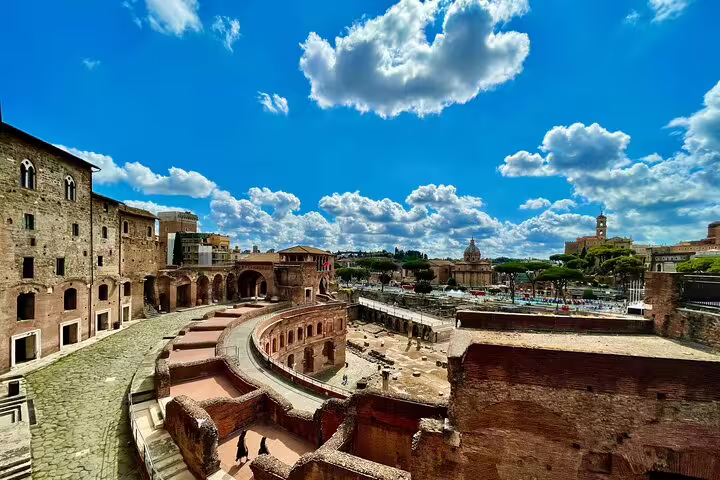 Panoramic view of Rome’s Trajan Markets and Imperial Forum ruins on a sunny day during a private skip-the-line guided tour