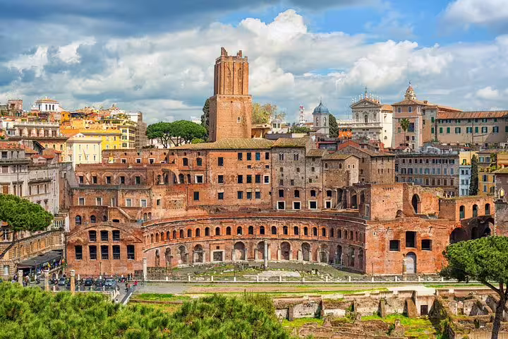 Panoramic view of Rome’s Trajan Markets and Imperial Forum ruins on a sunny day, featured on a skip-the-line private tour