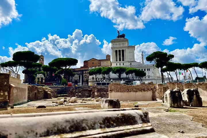 Ancient Imperial Forum ruins leading to the Vittoriano monument and skyline of Rome on a Trajan’s Markets private walking tour
