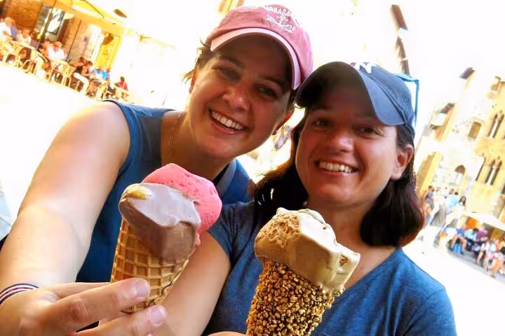 Two people enjoying gelato in Siena, capturing the essence of a delightful Tuscany day trip from Rome.