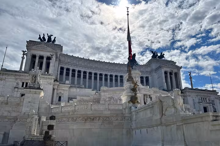 Majestic Vittoriano monument under a dramatic sky, a highlight of the Rome Highlights Tour with cultural sights.