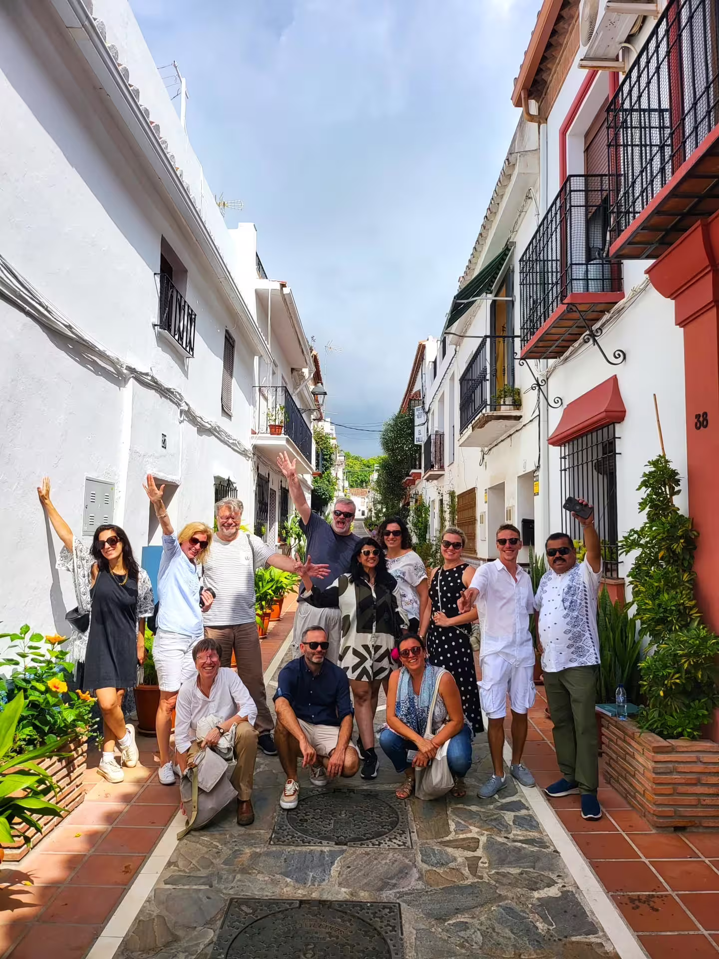 Small group in a whitewashed Marbella lane on a Ronda and Marbella private day trip with hotel pick-up from Costa del Sol