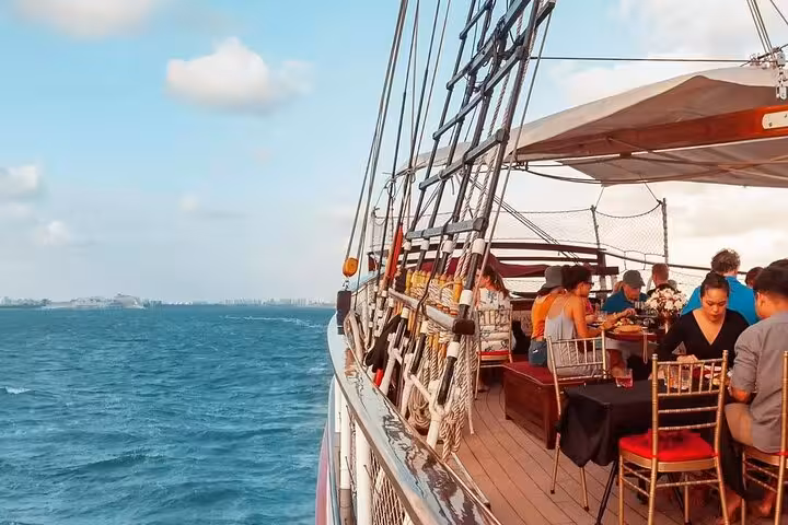 Scenic view of guests dining on the Royal Albatross breakfast cruise, with ocean backdrop and elegant seating.