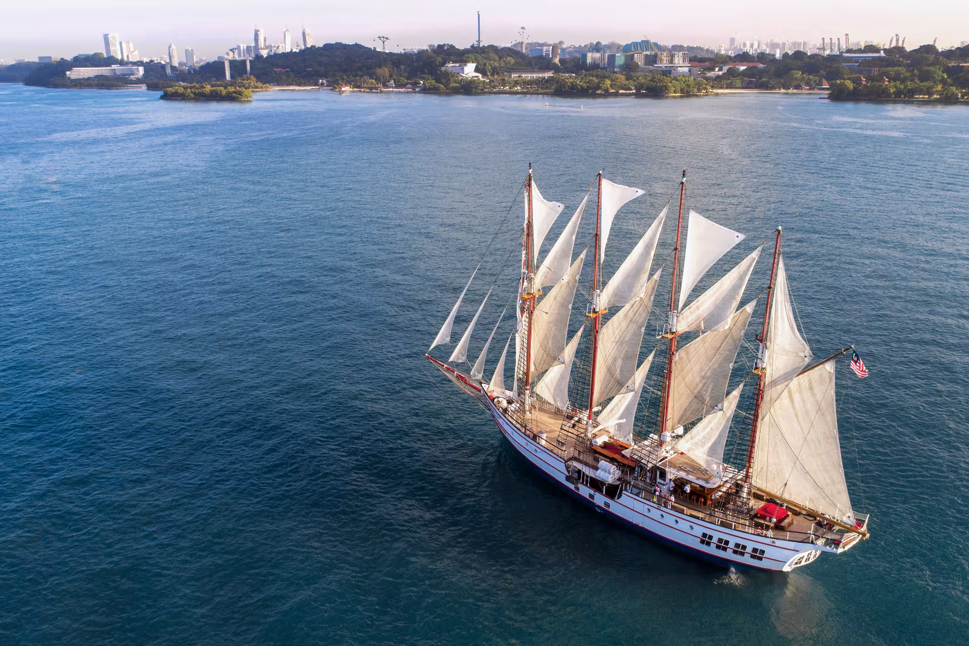 Majestic Royal Albatross sailing near Singapore's coastline, offering a unique breakfast cruise experience.