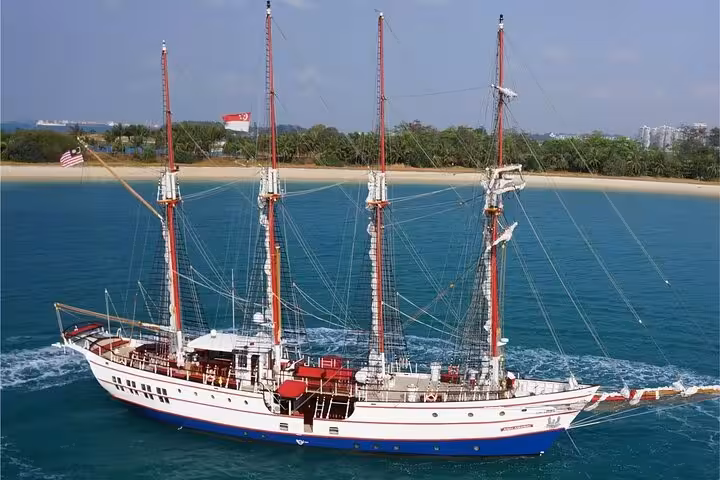 Majestic Royal Albatross sailing near Singapore coast, offering luxurious breakfast cruise experience with stunning views.
