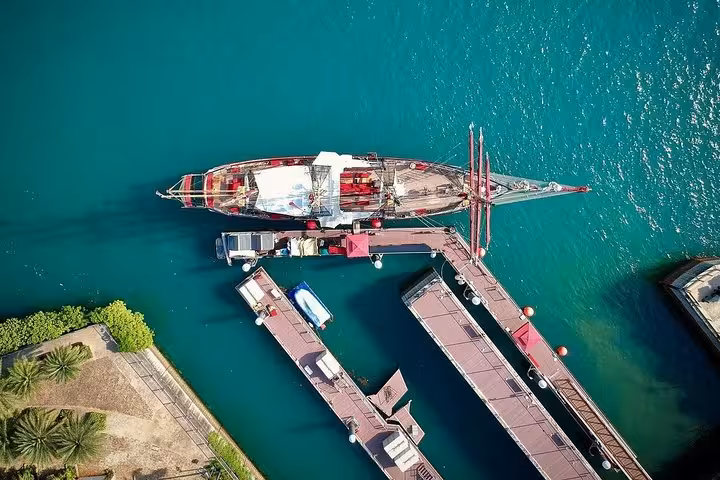 Aerial view of the Royal Albatross docked, ready for a scenic sunset sail cruise with a 5-course dining experience.