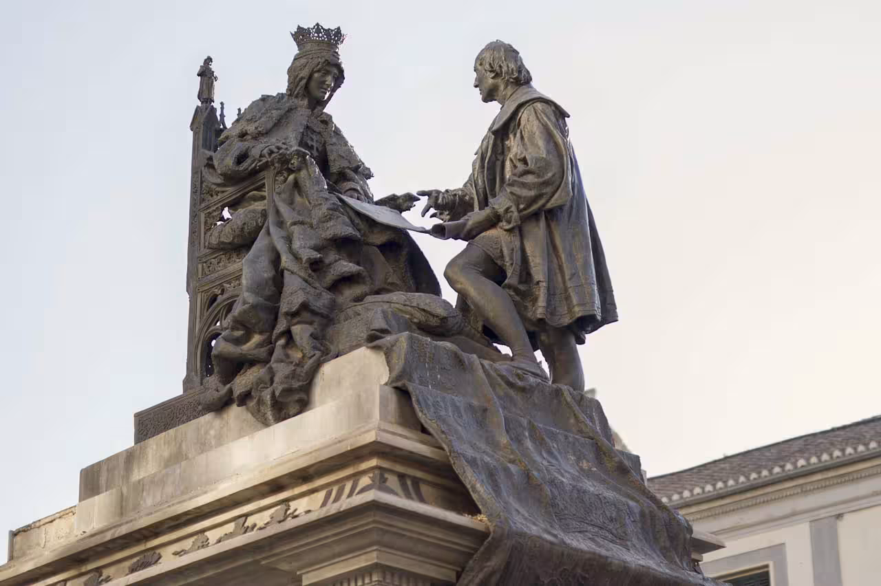 Ornate statues depicting historical figures on a pedestal, highlighting cultural richness on a Royal Chapel tour.