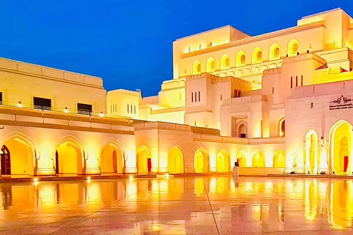 Illuminated courtyard of the Royal Opera House Muscat at night, a highlight in Oman’s 5-day package tour.