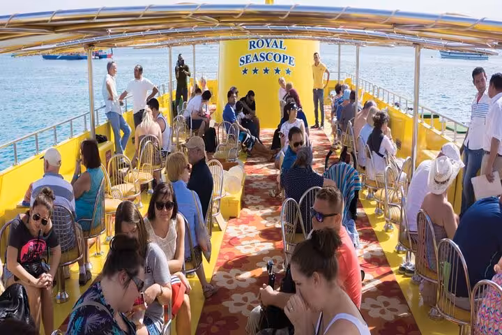 Guests relax on Royal Seascope boat deck in Sharm El-Sheikh before Red Sea submarine cruise with pickup