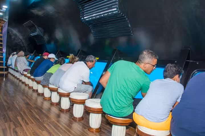 Passengers seated by panoramic windows inside Royal Seascope semi-submarine cruise in Sharm El-Sheikh